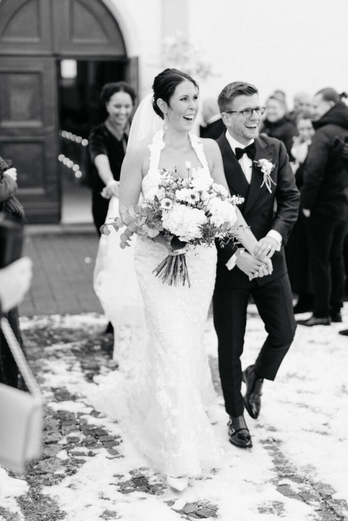 Bridal couple leaving church after wedding; Alpine-Wedding-Planner