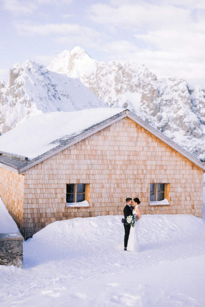 bridal couple in the snowy mountains after their wedding - Alpine-Wedding-Planner