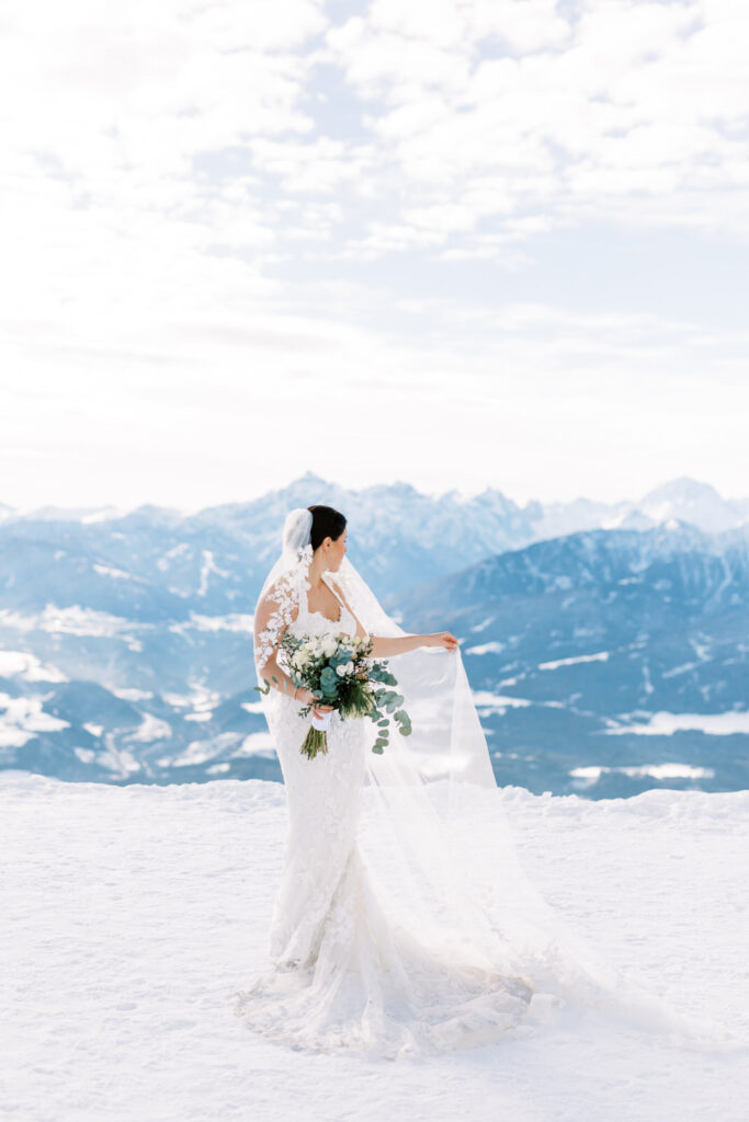 bride in the snowy mountains after her wedding - Alpine-Wedding-Planner